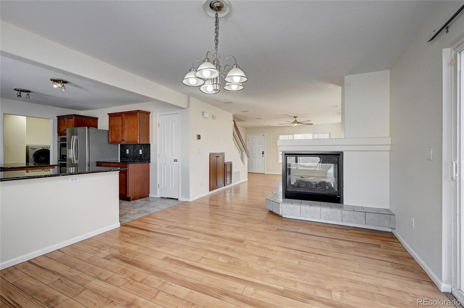 20527 Robins Drive Denver, CO 80249 - Photo 7 of 25 a view of a kitchen with a sink and a stove top oven