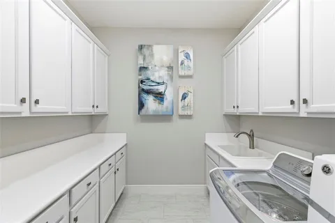a kitchen with stainless steel appliances granite countertop a sink dishwasher a oven with a dining table and chairs