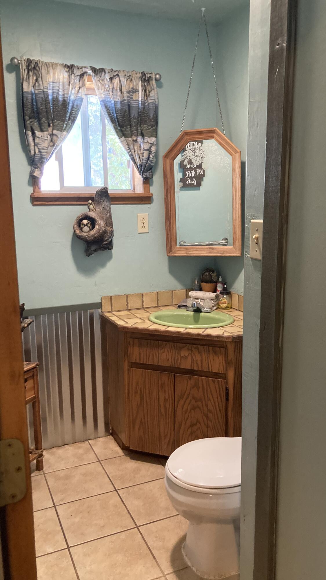640-540 Iris Road McArthur, CA 96056 - Photo 15 of 41 a bathroom with a toilet a sink and mirror