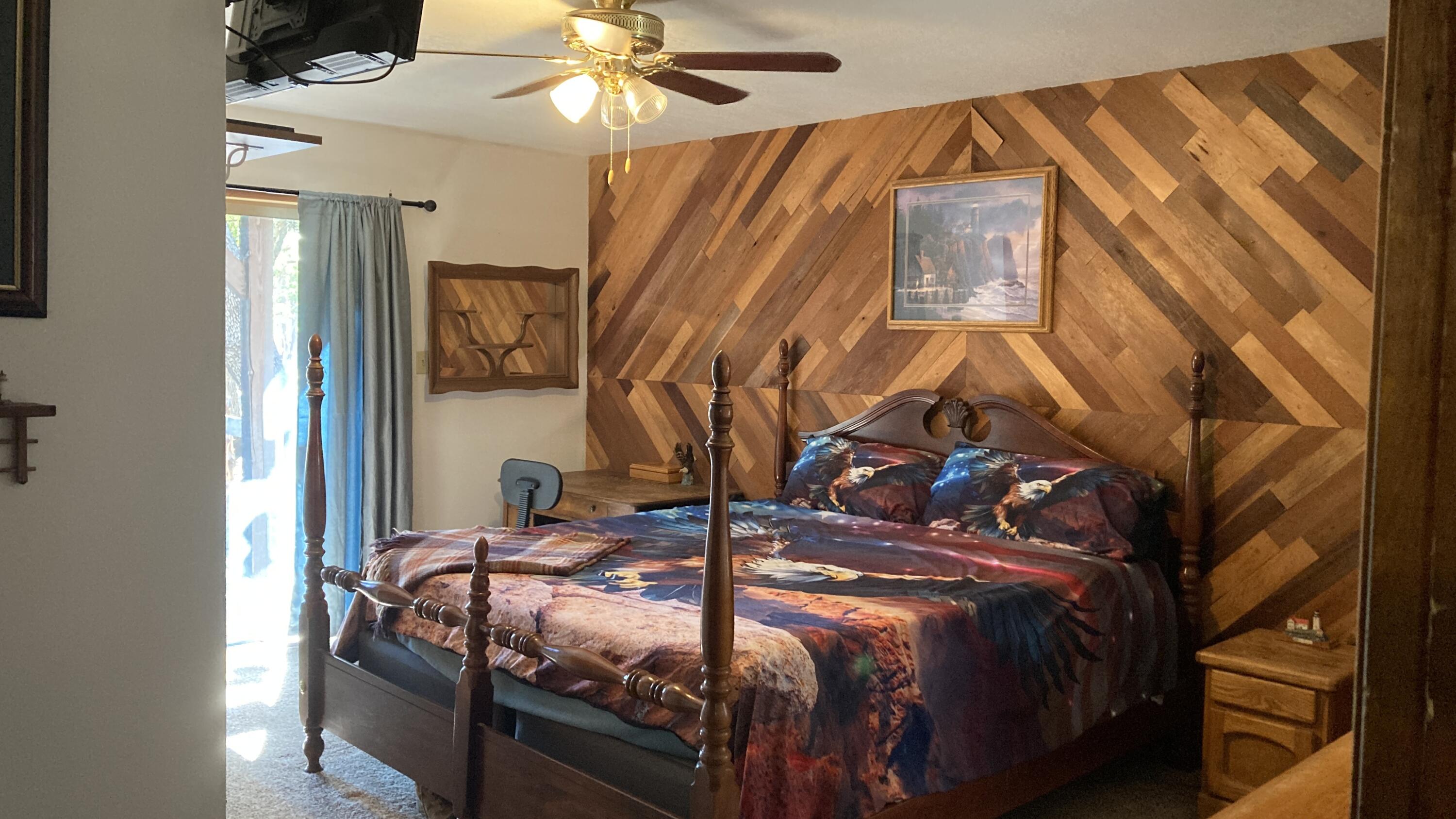 640-540 Iris Road McArthur, CA 96056 - Photo 16 of 41 a bedroom with a bed and wooden floor