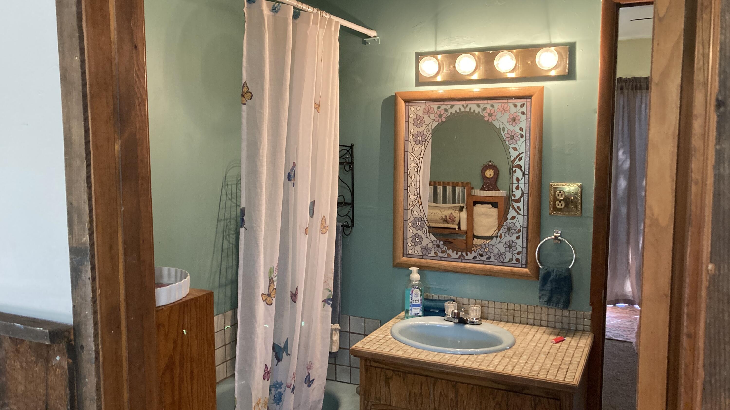 640-540 Iris Road McArthur, CA 96056 - Photo 34 of 41 a bathroom with a sink a mirror and a window