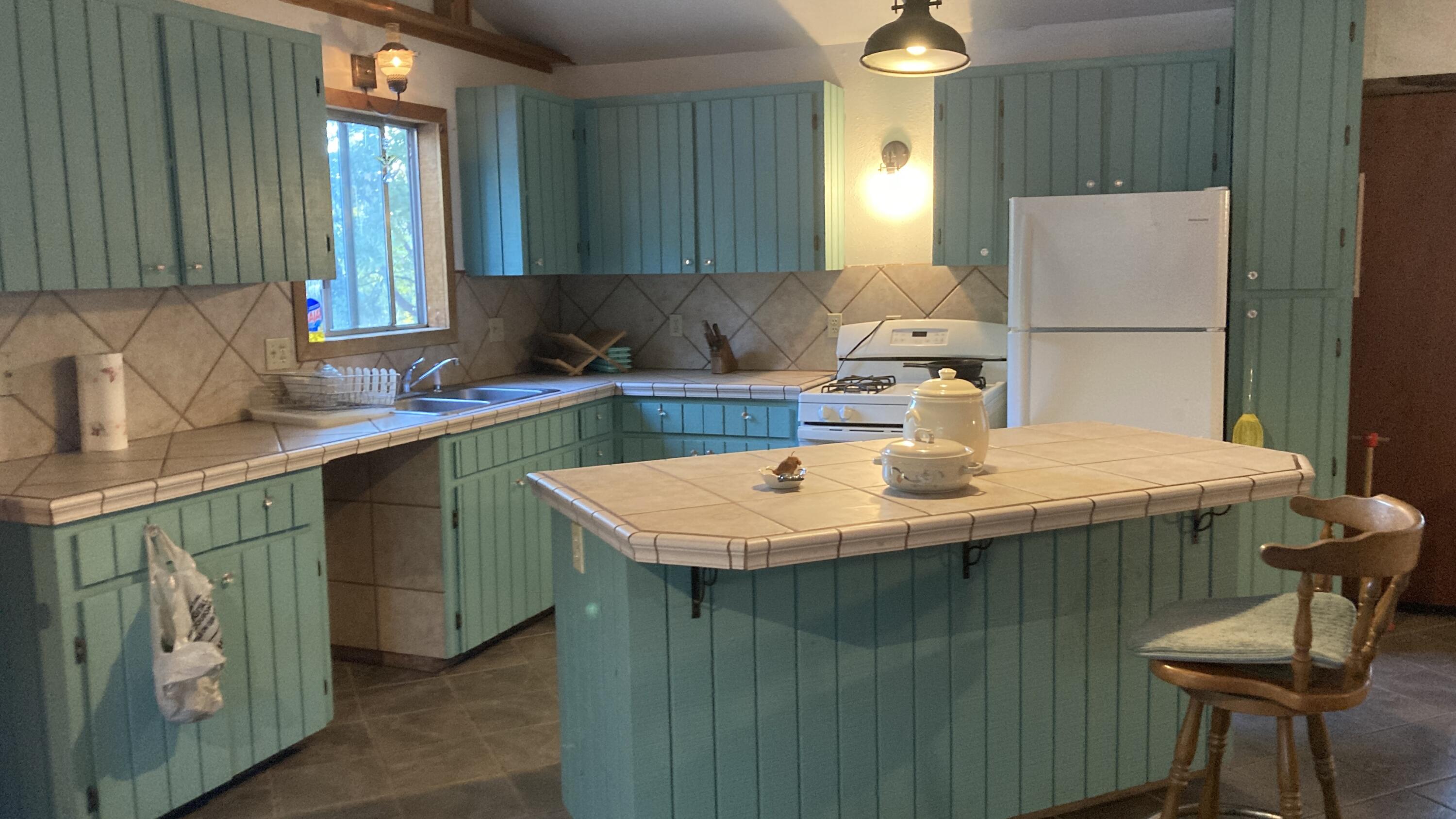 640-540 Iris Road McArthur, CA 96056 - Photo 38 of 41 a kitchen with a sink and a refrigerator