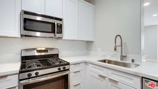 a kitchen with a stove and a microwave