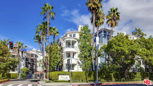 front view of a multi story building with a yard