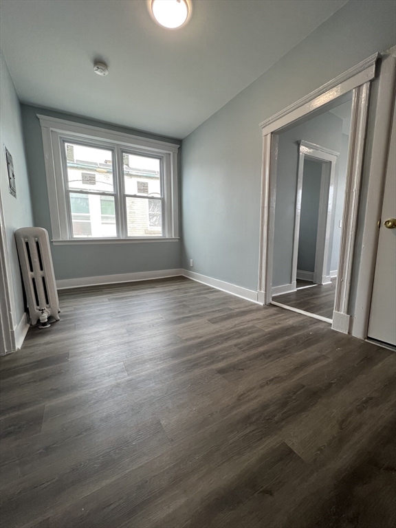 47 Hooker Street, Unit 3 Boston, MA 02134 - Photo 4 of 10 a view of empty room with wooden floor and fan
