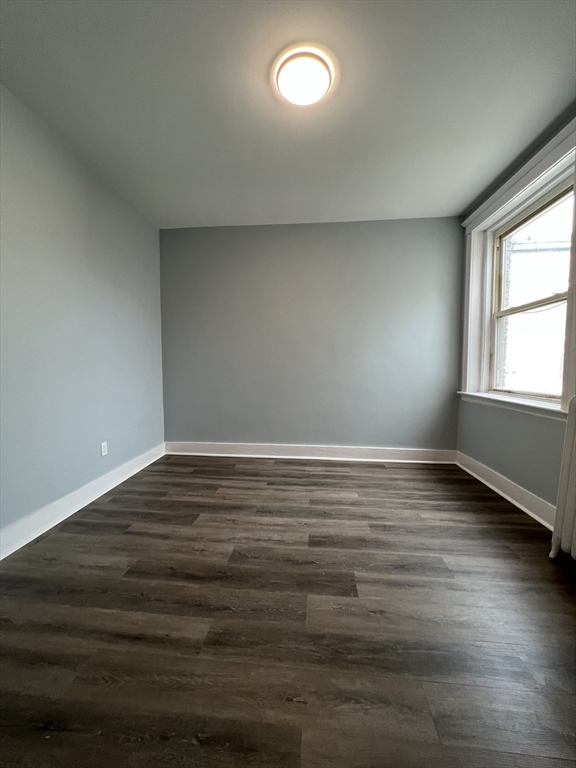 47 Hooker Street, Unit 3 Boston, MA 02134 - Photo 7 of 10 wooden floor in an empty room with a window