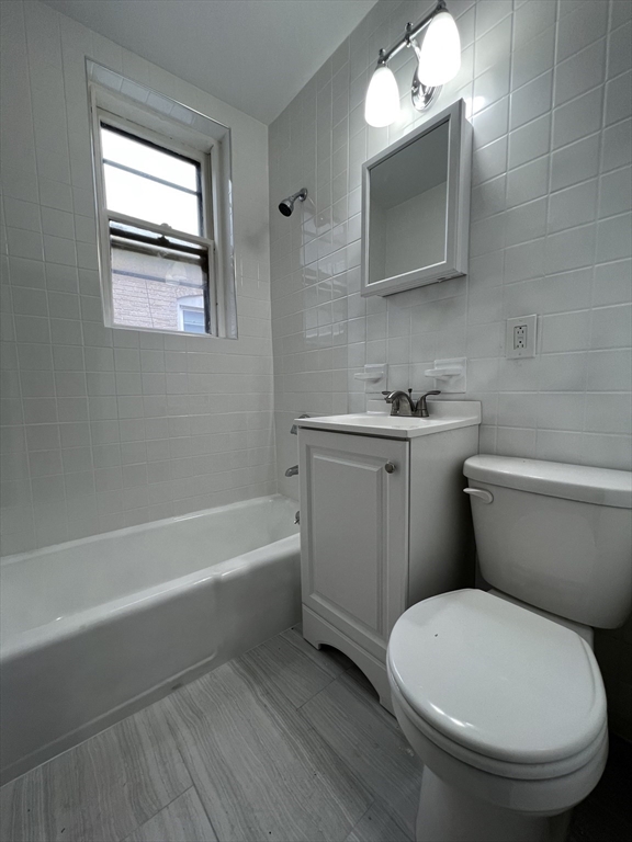 47 Hooker Street, Unit 3 Boston, MA 02134 - Photo 9 of 10 a bathroom with a toilet a sink and bathtub