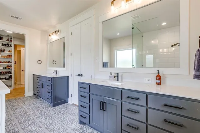 a spacious bathroom with a double vanity sink mirror and double