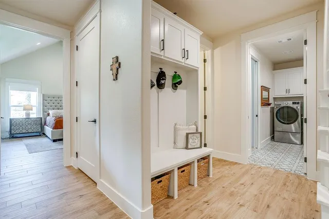 a view of a livingroom with wooden floor and furniture