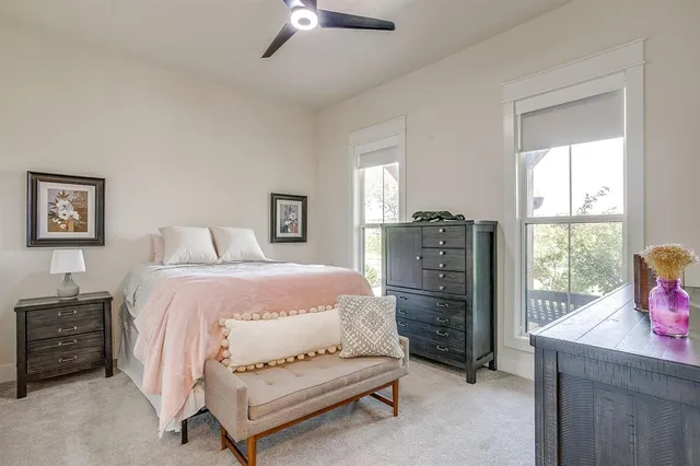 a spacious bedroom with a bed and a window