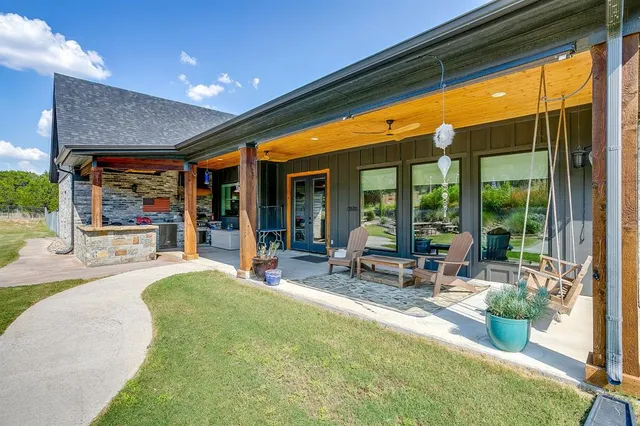 a swimming pool with outdoor seating and a garden