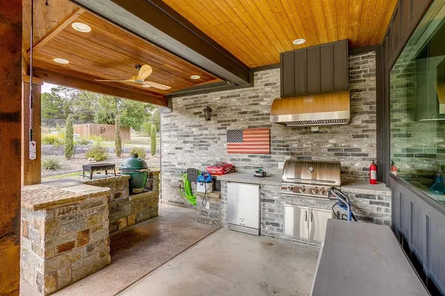 a open kitchen with stainless steel appliances granite countertop a stove a sink and a refrigerator