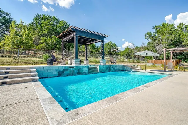 a view of swimming pool with a patio