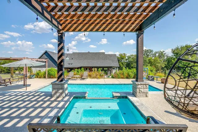 a view of a backyard with a patio and a fire pit