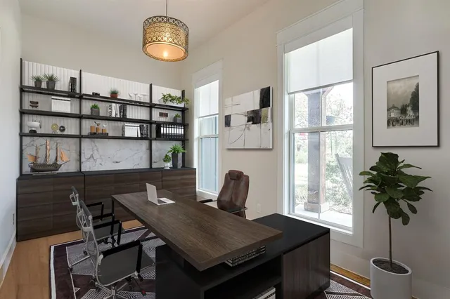 a view of a workspace with furniture and a potted plant