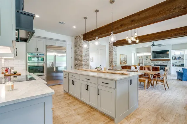 a kitchen with sink stove and cabinets
