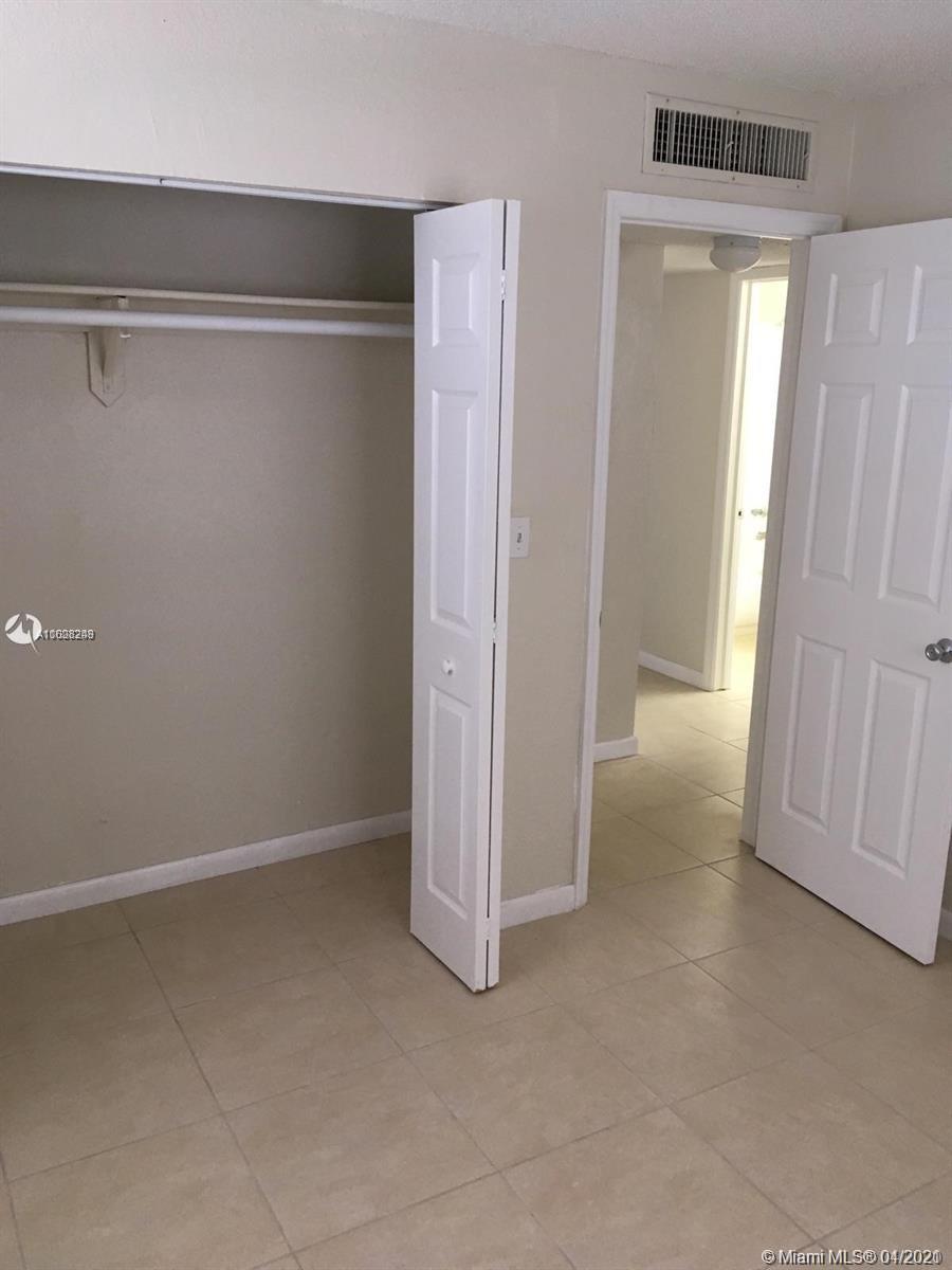 401 Southwest 13th Place, Unit 720 Deerfield Beach, FL 33441 - Photo 13 of 20 an empty room with a door
