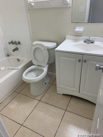 401 Southwest 13th Place, Unit 720 Deerfield Beach, FL 33441 - Photo 8 of 20 a bathroom with a sink a toilet and a mirror