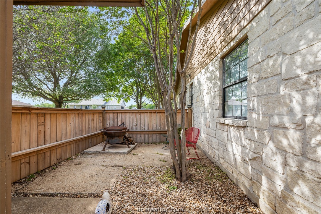 3540 Fisher Ranch Road Bryan, TX 77808 - Photo 22 of 36 a backyard with wooden fence and a large tree