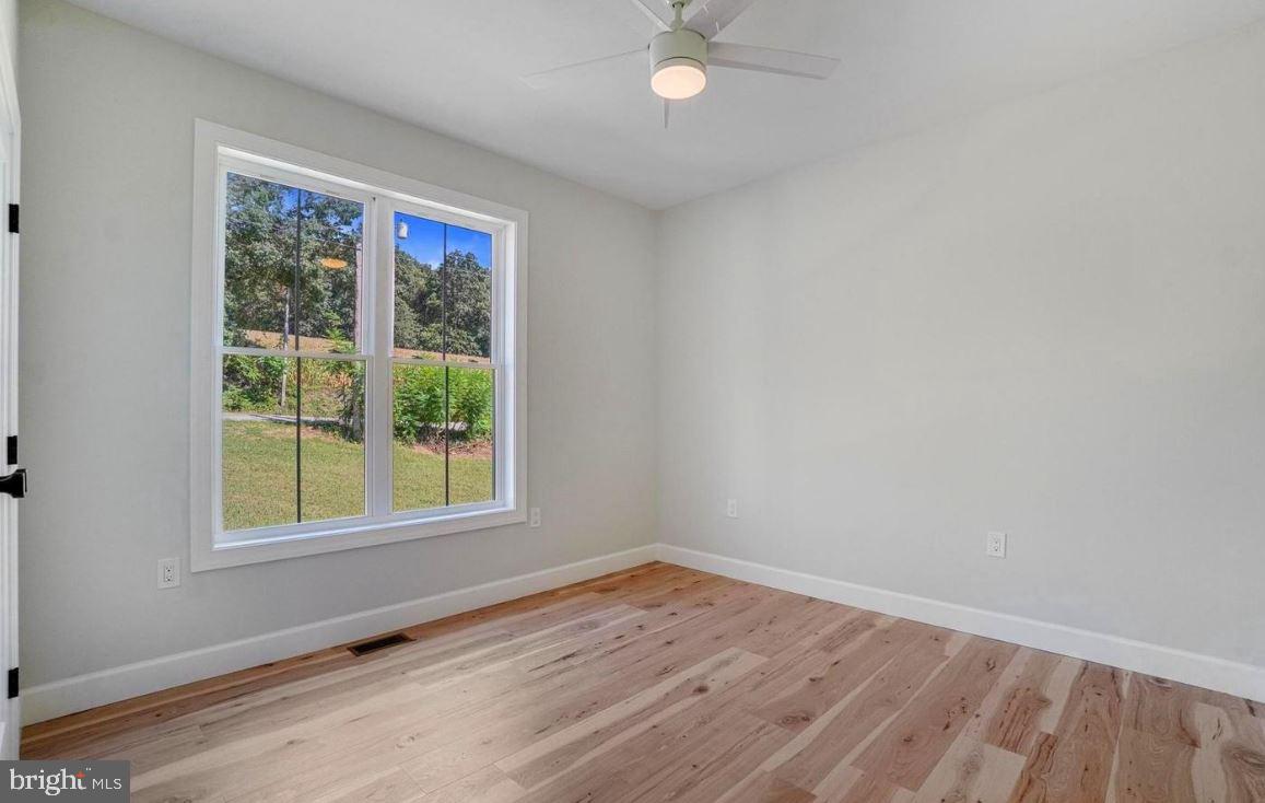 5 5 Forks Road New Freedom, PA 17349 - Photo 20 of 30 a view of an empty room with wooden floor and a window