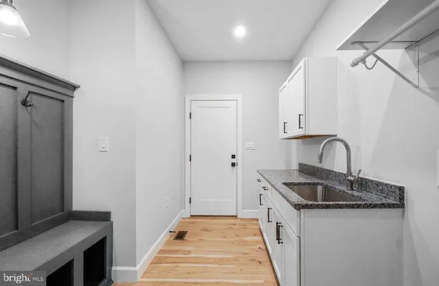 a kitchen with granite countertop a sink and cabinets