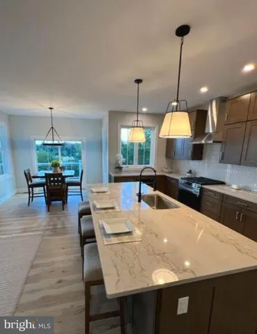 a large kitchen with a table and chairs