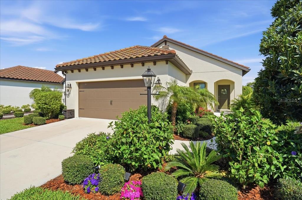 3511 Azurite Way Bradenton, FL 34211 - Photo 1 of 64 a front view of a house with a garden