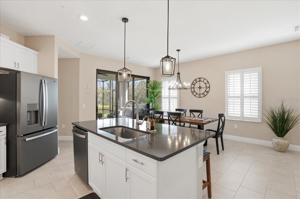 3511 Azurite Way Bradenton, FL 34211 - Photo 16 of 64 a kitchen with stainless steel appliances granite countertop a sink a stove and a center island