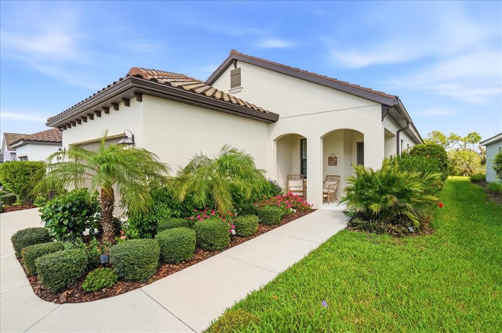 3511 Azurite Way Bradenton, FL 34211 - Photo 2 of 64 a front view of a house with garden
