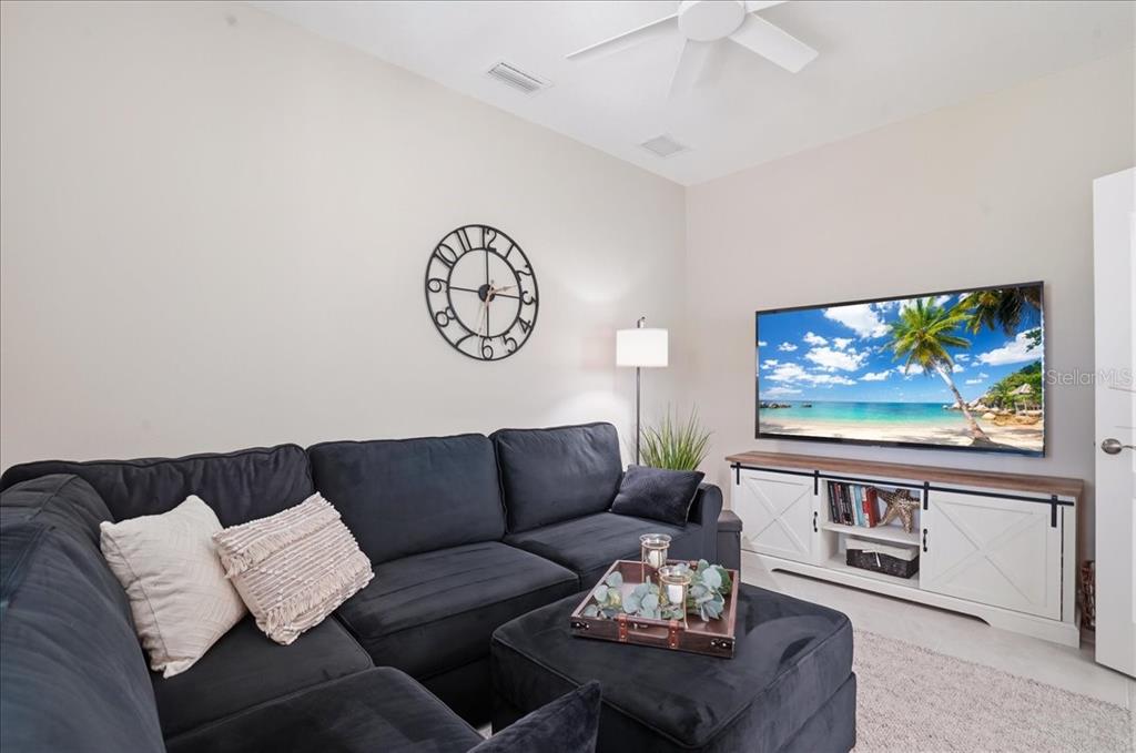 3511 Azurite Way Bradenton, FL 34211 - Photo 21 of 64 a living room with furniture a couch and a flat screen tv