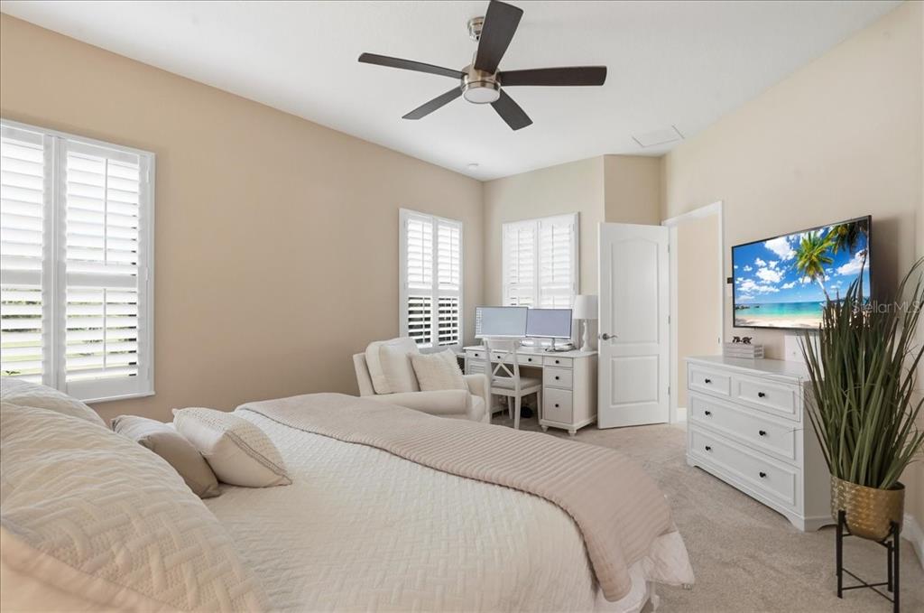 3511 Azurite Way Bradenton, FL 34211 - Photo 25 of 64 a bedroom with bed and a flat tv screen on dresser