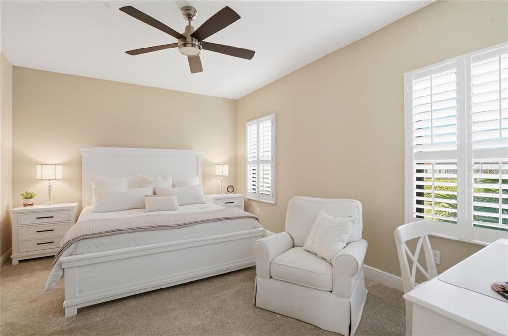 3511 Azurite Way Bradenton, FL 34211 - Photo 26 of 64 a bedroom with a bed a couch and a large window
