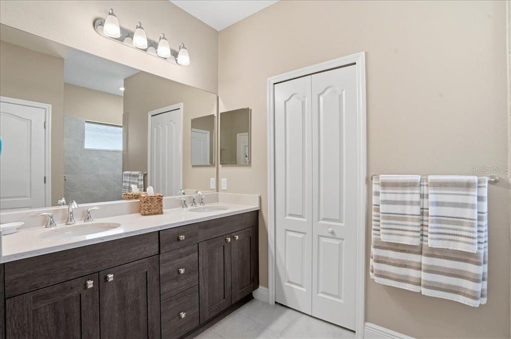3511 Azurite Way Bradenton, FL 34211 - Photo 27 of 64 a bathroom with a double vanity sink and a mirror