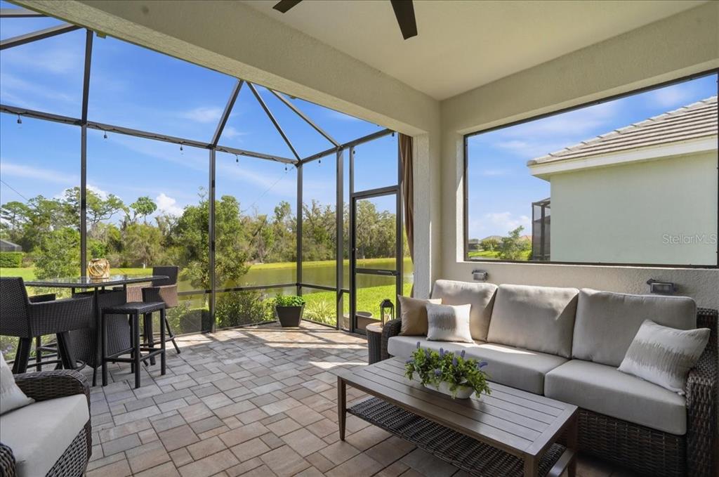 3511 Azurite Way Bradenton, FL 34211 - Photo 40 of 64 a living room with furniture and a floor to ceiling window
