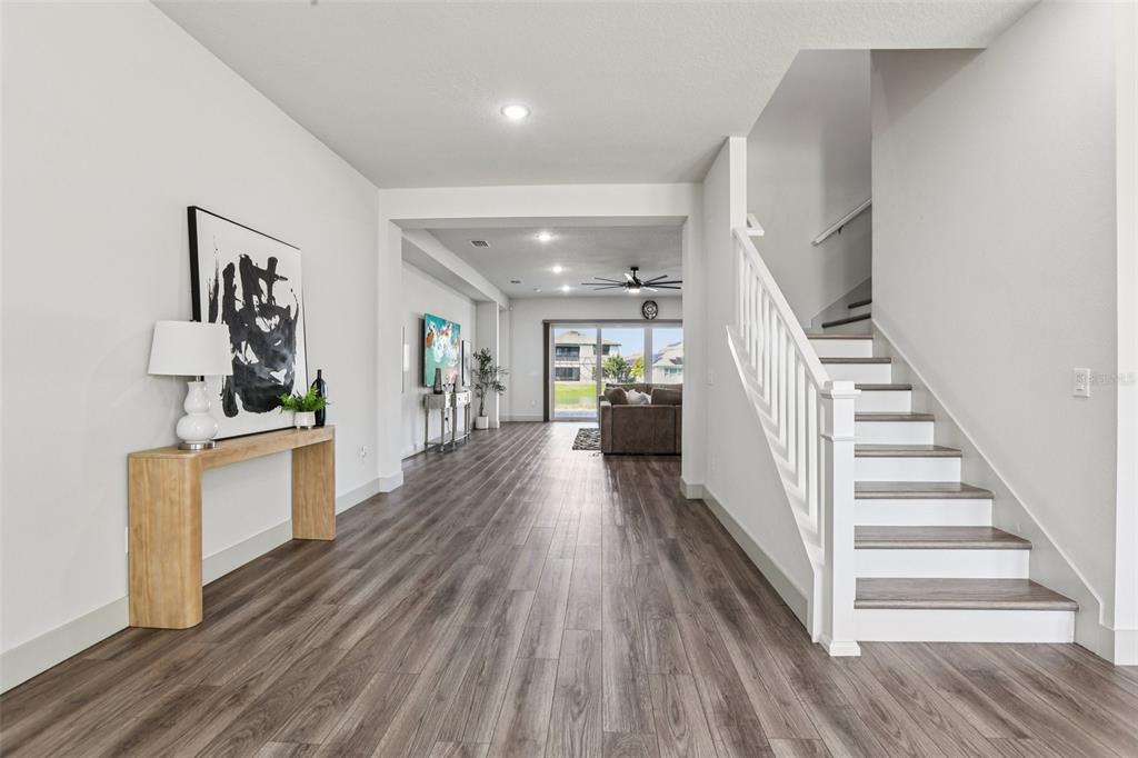 8743 Sanders Tree Loop Wesley Chapel, FL 33545 - Photo 23 of 41 a view of a hallway with wooden floor and furniture