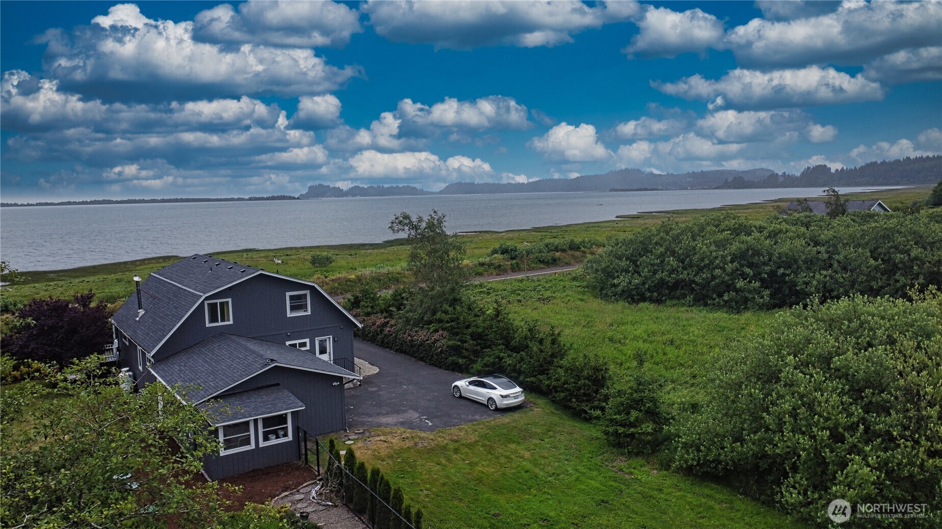 240 Stringtown Road Ilwaco, WA 98624 - Photo 2 of 39 an aerial view of a house with garden space and street view