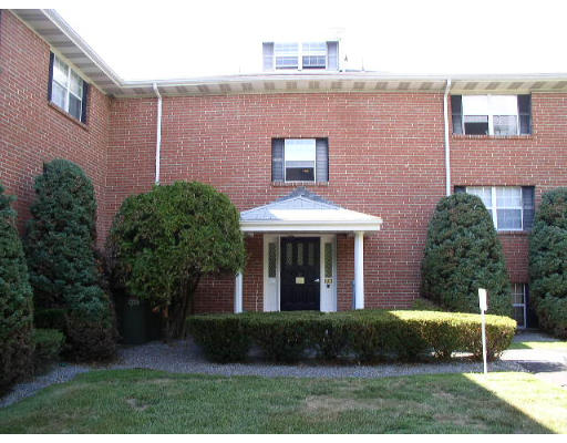 12 Leonard Road, Unit 12 Boxborough, MA 01719 - Photo 1 of 4 a view of a brick house with a yard and plants