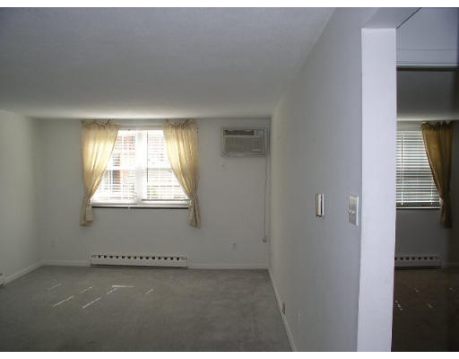12 Leonard Road, Unit 12 Boxborough, MA 01719 - Photo 2 of 4 a view of an empty room with a window