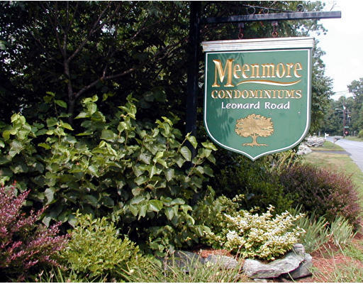 12 Leonard Road, Unit 12 Boxborough, MA 01719 - Photo 4 of 4 a sign that is sitting on a brick wall
