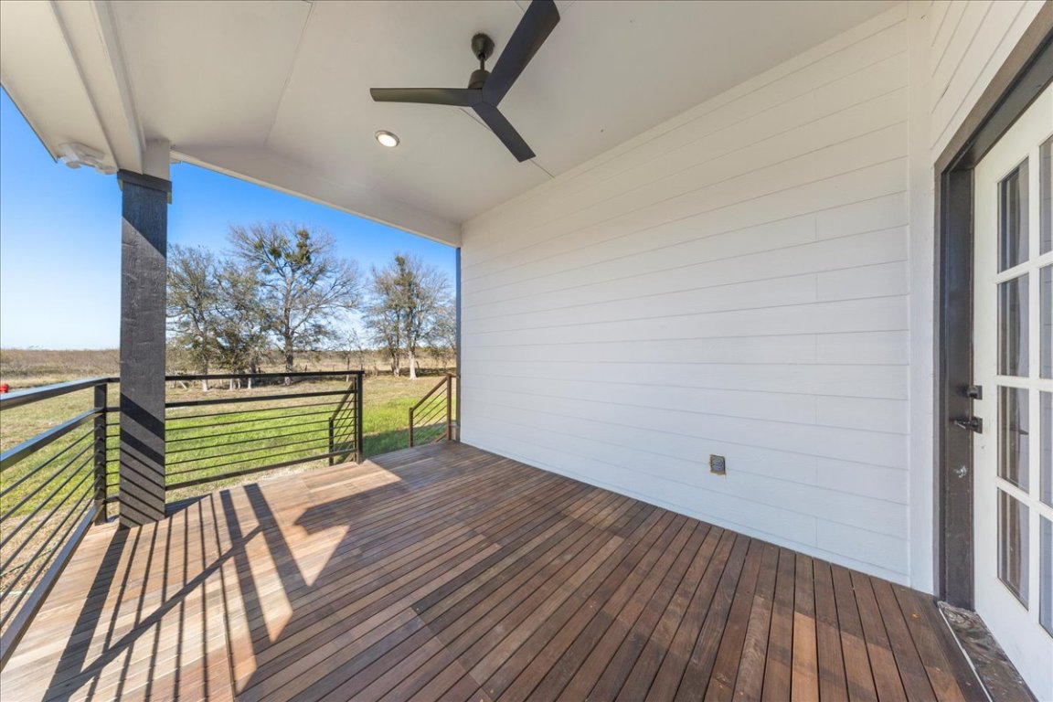 217 Gato Road Cedar Creek, TX 78612 - Photo 37 of 39 Wooden deck with a ceiling fan and a lawn