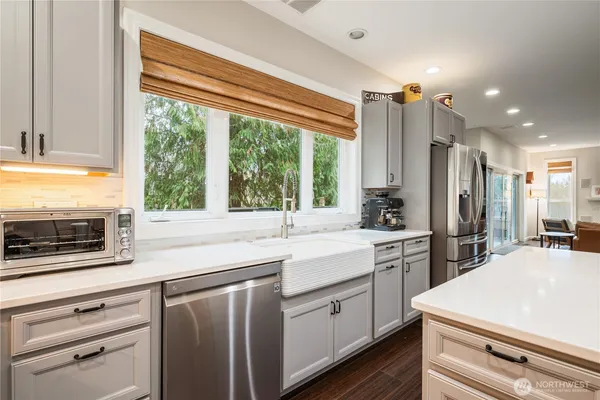 a kitchen with appliances cabinets and a sink