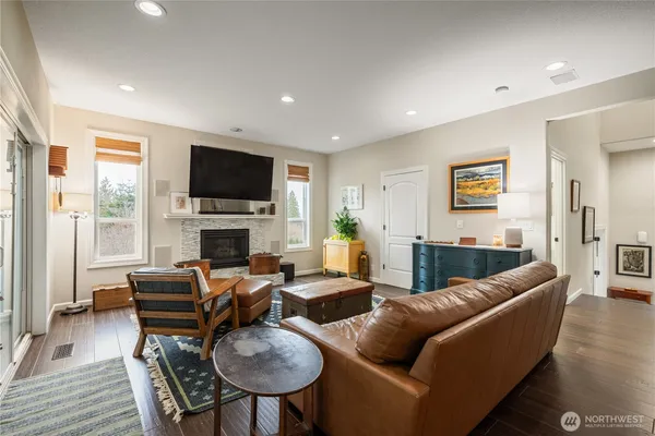 a living room with furniture a fireplace and a flat screen tv