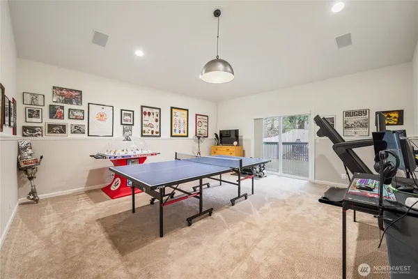 a room with furniture gym equipment and a wooden floor