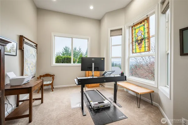 a living room with furniture a window and a flat screen tv
