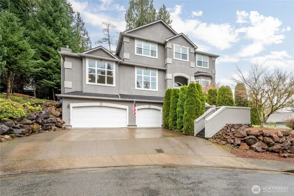 a front view of a house with a yard and garage