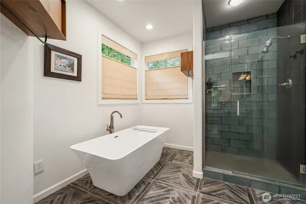 a bathroom with a sink a shower and a mirror