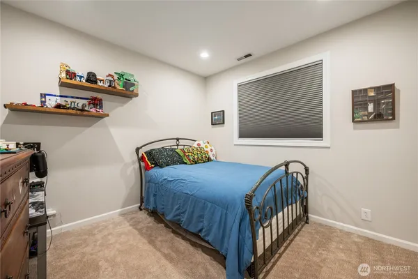 a bedroom with furniture and a window