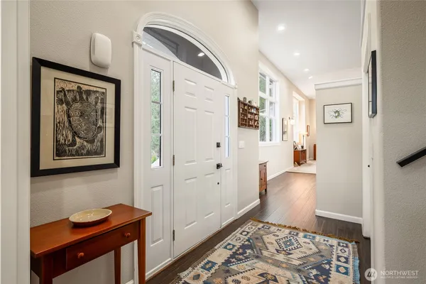 a hallway with furniture and wooden floor