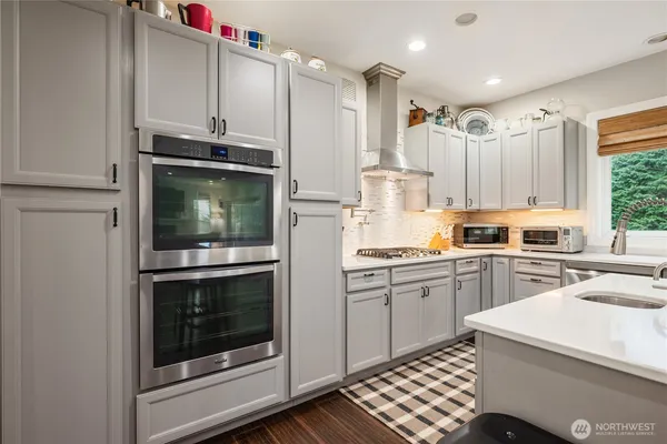 a kitchen with a sink stove and microwave