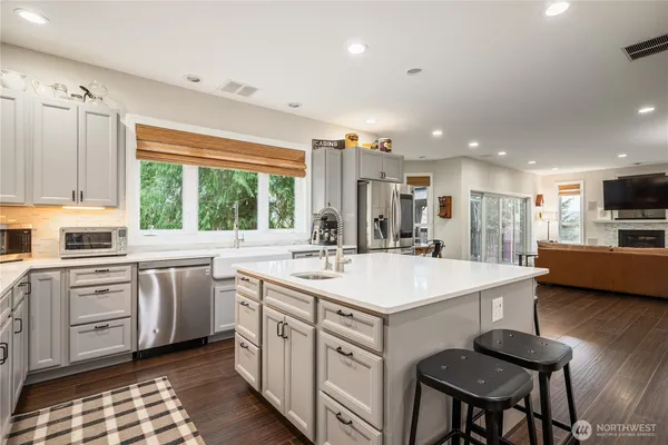 a kitchen with a stove a sink and a refrigerator